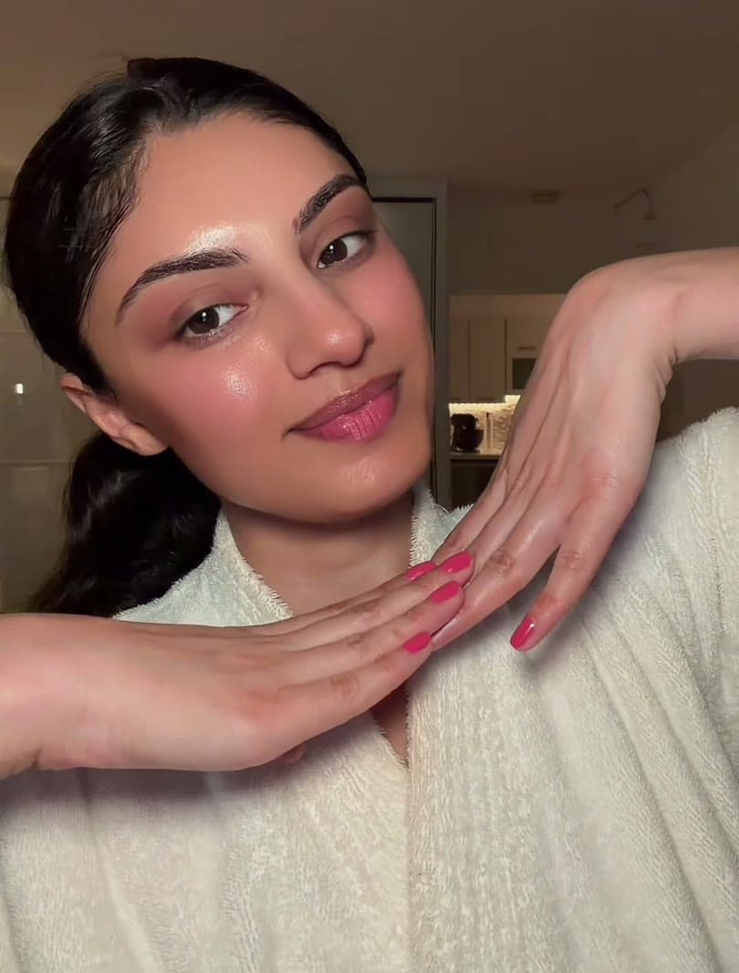 Sarina applying skincare while filming a Medicube brand video
